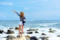 Woman on the stone on the seashore Royalty Free Stock Photo