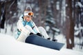 Young woman strapping on Snowboard Royalty Free Stock Photo
