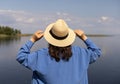 young woman in a straw hat, background of the blue sea Royalty Free Stock Photo