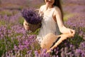 Young woman with straw hat in lavender field on summer day Royalty Free Stock Photo