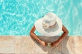 Young woman in a straw hat with tropical cocktail in a pool Royalty Free Stock Photo