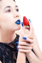 Young woman with strawberry and blue nails