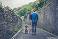 Young woman in street with Leonberger puppy Royalty Free Stock Photo