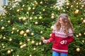 Young woman on a street of Paris decorated for Christmas Royalty Free Stock Photo