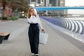 Young woman at the street with shopping bags talking on mobile phone Royalty Free Stock Photo