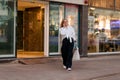 A young woman on the street with shopping bags talking on a mobile phone Royalty Free Stock Photo