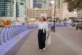 A young woman on the street with shopping bags talking on a mobile phone Royalty Free Stock Photo