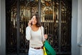 Young woman at the street with shopping bags talking on mobile phone Royalty Free Stock Photo