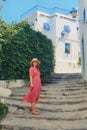 A young woman on street Sidi Bou Said. House with blue windows and doors with Arabic ornaments, Sidi Bou Said, Tunisia, Africa Royalty Free Stock Photo