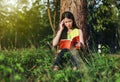 Woman in stress situation when reading a book in the park