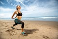 Young woman stretching on beach Royalty Free Stock Photo