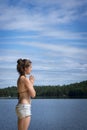 Young Woman stretching on cedar dock