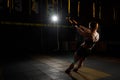 Young woman stretching her body while doing fitness TRX training exercises at gym Royalty Free Stock Photo