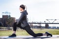 Young woman stretching her quadriceps muscles by grabbing her ankle