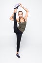 Young woman stretching legs isolated over white background Royalty Free Stock Photo