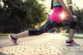 Young woman stretching before morning run in park, closeup Royalty Free Stock Photo