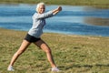 Young woman stretching outdoors before jogging Royalty Free Stock Photo