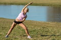 Young woman stretching outdoors before jogging Royalty Free Stock Photo