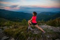 Young woman stretching after trail cross country running in mountains Royalty Free Stock Photo