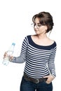 A young woman in a striped tight blouse holds in her right hand a bottle with clean drinking water Royalty Free Stock Photo