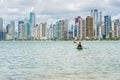 Young woman strolling by kayak on Brazilian beach. Fishing kayak Royalty Free Stock Photo