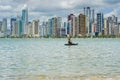 Young woman strolling by kayak on Brazilian beach. Fishing kayak Royalty Free Stock Photo