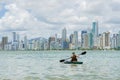 Young woman strolling by kayak on Brazilian beach. Fishing kayak