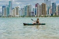 Young woman strolling by kayak on Brazilian beach. Fishing kayak Royalty Free Stock Photo