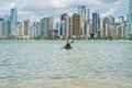 Young woman strolling by kayak on Brazilian beach. Fishing kayak Royalty Free Stock Photo