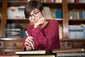 Young woman student cheerful in the library Royalty Free Stock Photo