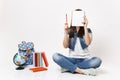 Young woman student in denim clothes holding pencil covering face with notebook sitting near globe, backpack, school Royalty Free Stock Photo