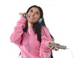 Young woman or student girl with mobile phone listening to music headphones singing and dancing Royalty Free Stock Photo