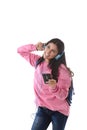 Young woman or student girl with mobile phone listening to music headphones singing and dancing Royalty Free Stock Photo