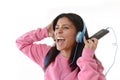 Young woman or student girl with mobile phone listening to music headphones singing and dancing Royalty Free Stock Photo