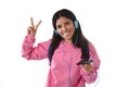 Young woman or student girl with mobile phone listening to music headphones singing and dancing Royalty Free Stock Photo