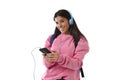 Young woman or student girl with mobile phone listening to music headphones singing and dancing Royalty Free Stock Photo