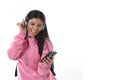 Young woman or student girl with mobile phone listening to music headphones singing and dancing