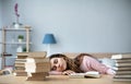 Young woman student with many books sleeping