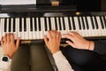 Young woman with student playing piano, above view. Music lesson Royalty Free Stock Photo