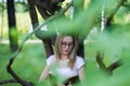 Young woman student reading a book leaning on a tree in the park Royalty Free Stock Photo