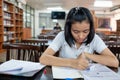 Young woman student reading a book with stress Royalty Free Stock Photo