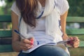 Young woman student sitting on a bench in the Park Royalty Free Stock Photo