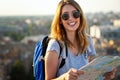 Young woman, student traveler with backpack enjoying summer vacation.