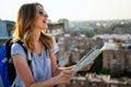 Young woman, student traveler with backpack enjoying summer vacation.