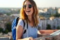 Young woman, student traveler with backpack enjoying summer vacation.