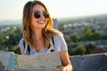 Young woman, student traveler with backpack enjoying summer vacation.