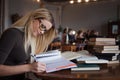 Young woman student of the University. Preparing exam and learning lessons in public library. Royalty Free Stock Photo