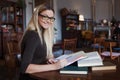 Young woman student of the University. Preparing exam and learning lessons in public library. Royalty Free Stock Photo