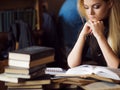 Young woman student of the University. Preparing exam and learning lessons in public library. Royalty Free Stock Photo