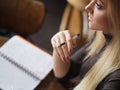 Young woman student of the University. Preparing exam and learning lessons in public library. Royalty Free Stock Photo